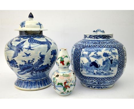 Two 19th century Chinese blue and white jars with covers, one decorated with panels of figures and flowers, one decorated wit