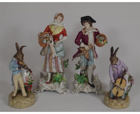 A pair of Volkstedt figurines of rabbits playing instruments, together with a pair of Sitzendorf figurines of a man and a wom