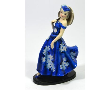 A Goldscheider glazed figure of a woman in a blue dress with a parasol, designed by Claire Herczeg. Model 8361 7 10. Impresse