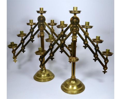 A pair of brass articulated seven light candelabra or menorahs by Vanpoulle of Westminster. Circa 20th century. Maximum Heigh