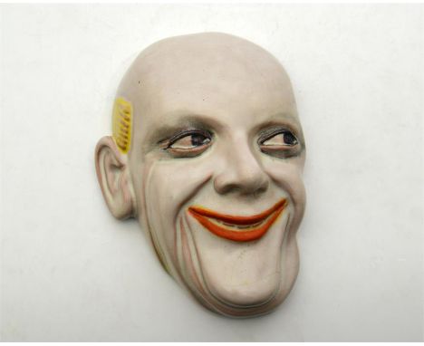 A Goldscheider wall mask of a laughing clown, 6640. Impressed marks. Length 19.5cm.