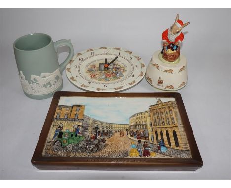 A mixed lot consisting of a Royal Doulton Bunnykins music box, a Bunnykins clock, a Beswick wall plaque and a Dudson jasperwa