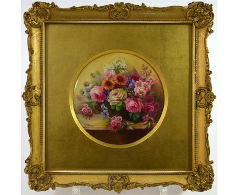 A Royal Worcester circular plaque, decorated with a basket of summer flowers, circa 1911. Signed E. Phillips, glazed and fram