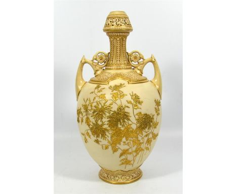 A Royal Worcester twin handled vase of baluster form, with gilded flowers on a blush ivory ground, shape number 1200, circa 1
