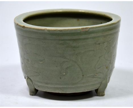 A Chinese celadon porcelain censer, incised with stylised flowering plants and set upon three scroll feet. Ming Dynasty. Diam