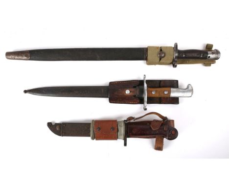 Three bayonets. A British P1907 Lee Enfield SMLE bayonet with round frog stud by Sanderson, dated 1919, in steel scabbard and