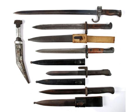 A collection of five bayonets. An early 20th century sword bayonet, a German M1884/98 bayonet, a FN Light Automatic Rifle bay