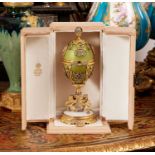 A FABERGE STYLE DIAMOND ENCRUSTED, GUILLOCHE ENAMEL AND SILVER GILT SURPRISE EGG