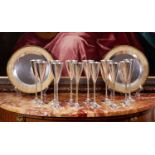 STUART DEVLIN: A SET OF TWELVE STERLING SILVER AND PARCEL GILT MODERNIST CHAMPAGNE FLUTES