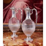 A FINE PAIR OF 19TH CENTURY FRENCH SILVER AND GLASS CLARET JUGS