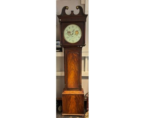 A reproduction flame mahogany grandfather clock surmounted by scroll detail the face with hand painted shield detail ( Penman