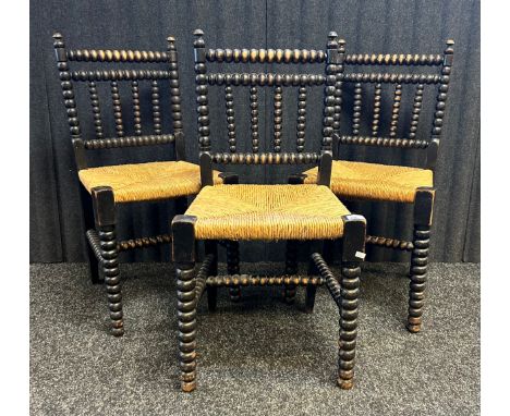 Three arts and crafts bobbin turned chairs with woven seats.