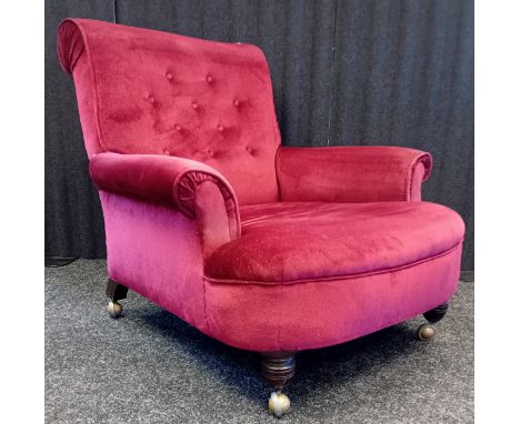 Victorian Button back chair in red velvet upholstery, on turned legs ending in metal castors