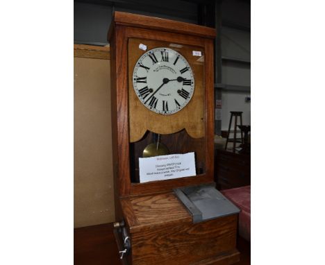 An early C20th, vintage oak frame clocking on/off clock