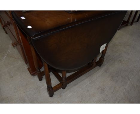 A mid 20th Century dark stained gateleg table, Ercol or similar