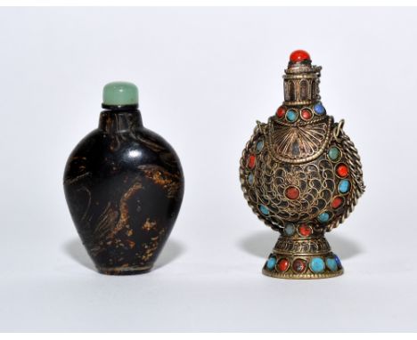 A Bhutanese copper snuff bottle 19th/20th Century flask shaped with chain linked stopper, body overlaid with cloisonne style 