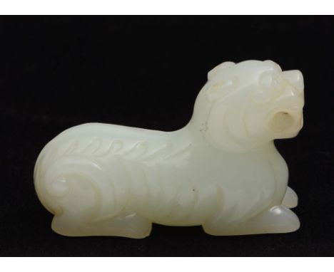 A jade carved dog 20th Century in the Ming style, the dog resting on all four paws, 5cm