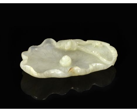 A Chinese white jade brush washer 19th Century carved as a lotus leaf within which is a snail, the raised edges carved with d