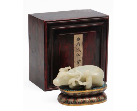 A Chinese white jade carving of a recumbent water buffalo 19th/20th Century carved in open work along side a standing herdsbo