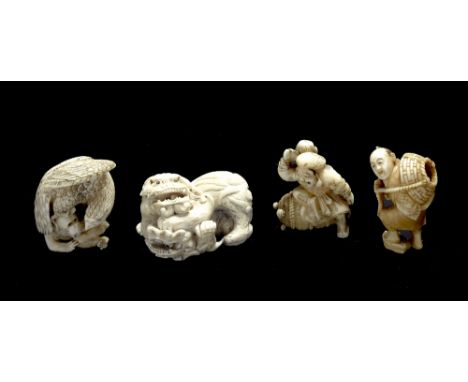 A Japanese ivory netsuke of Daikoku late 19th Century holding his mallet and seated upon a rice bale upon which are five tama