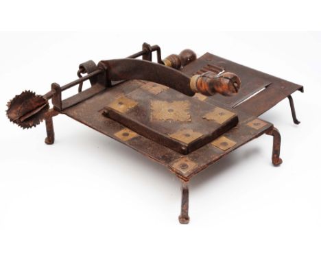 A Persian kitchen implement of metal construction with engraved brass brackets, consisting tools for grating slicing and chop