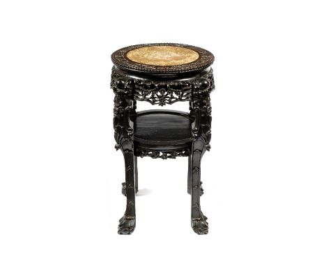 A Chinese hardwood large circular urn stand late 19th Century the top border carved with bamboo and flower heads, with carved