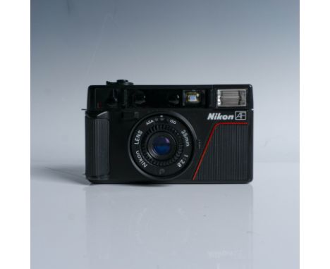 Nikon L35AF 35mm film camera, introduced in 1983, featuring a Nikkor 35mm f/2.8 lens. This model, one of Nikon's earliest aut
