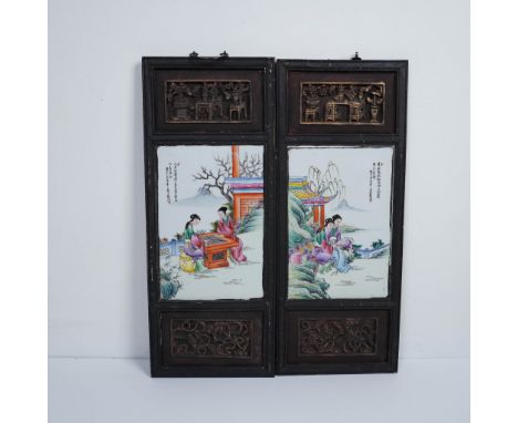 A finely executed pair of Chinese porcelain plaques, each set within an ornately carved wooden frame featuring openwork desig
