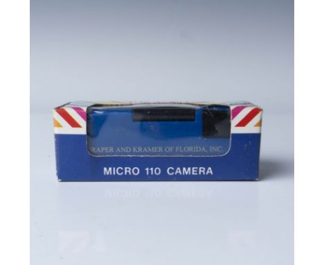 A vintage Hi-Tech Micro 110 Camera, model No. 120-1, housed in its original packaging. This compact camera features a flip-up