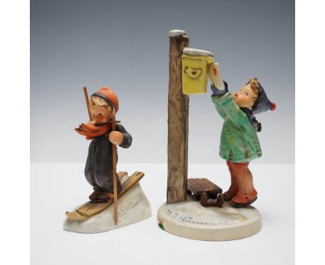 Delightful pair of Goebel Hummel porcelain figurines titled A Letter to Santa Claus and Skier. A Letter to Santa Claus featur