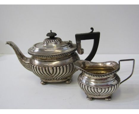 EDWARDIAN SILVER TEAPOT AND MILK JUG, with half fluted decoration on bun feet with ebony handle and finial, Birmingham hallma