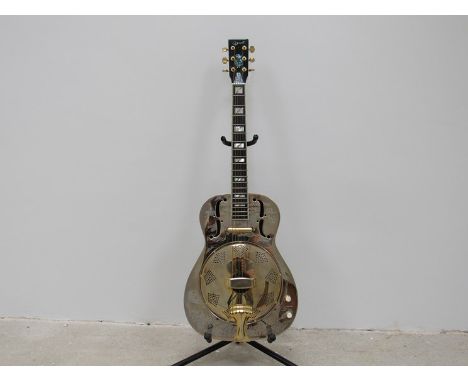 An Ozark resonator guitar with gold and metallic body, pineapple design headstock, camouflage case 