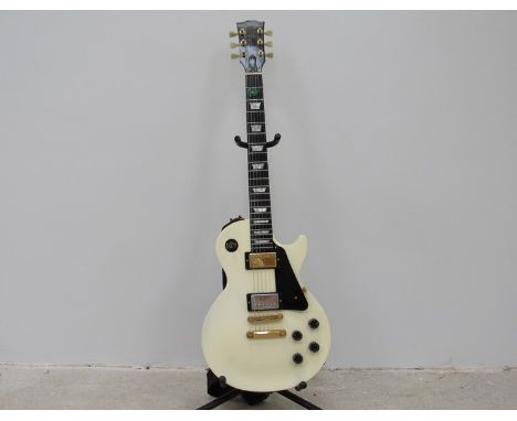 A Gibson Les Paul Studio in Alpine white with gold coloured hardware and black pickguard, serial no. 92346527 dating to Augus