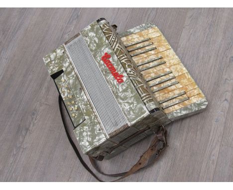 A Carmelo cased 12 bass accordion 