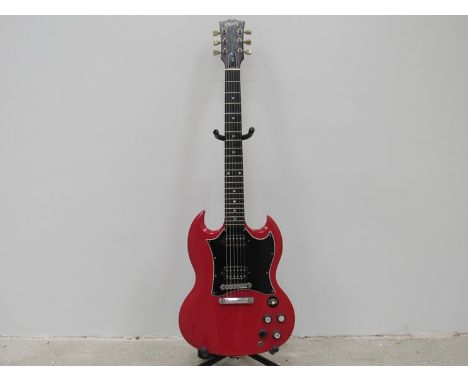 A Gibson SG in candy apple red, black pick guard and wood grain headstock, serial no. 90185326, 18th January 1995, Nashville 