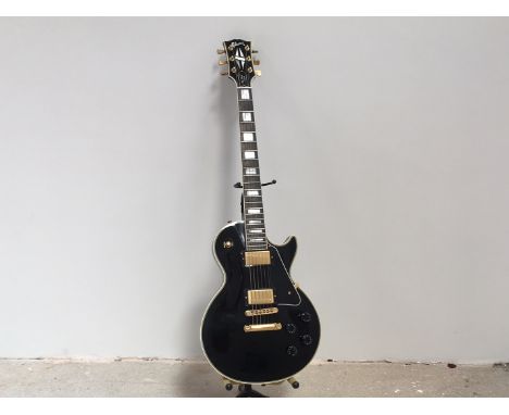 A Gibson Les Paul '57 re-issue, in black, serial CS 000708, gold coloured hardware, original case, with certification. Dating