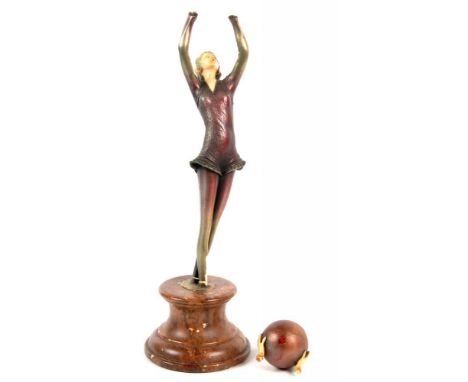 AN ART DECO PATINATED IVORINE STATUETTE IN THE FORM OF AN EXOTIC DANCER, ON COMPOSITION SOCLE, 36CM H, C1930, FAULTS 