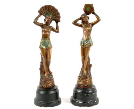 A PAIR OF ART DECO GILT AND PATINATED SPELTER STATUETTES OF BIKINI DANCERS, WITH FAN OR TAMBOURINE, ON BLACK PAINTED PLASTER 