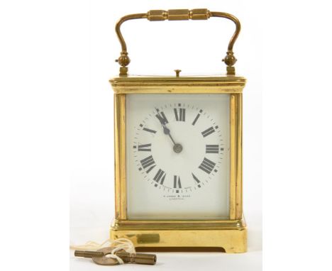 A BRASS CARRIAGE CLOCK, THE WHITE ENAMEL MASK DIAL INSCRIBED R JONES AND SONS LIVERPOOL, THE MOVEMENT RETAINING THE ORIGINAL 