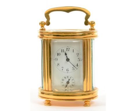A CONTINENTAL MINIATURE BRASS OVAL CARRIAGE CLOCK, THE ALARM TIMEPIECE RETAINING THE ORIGINAL PLATFORM LEVER ESCAPEMENT, 7CM 