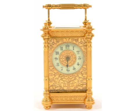 A FRENCH BRASS CARRIAGE CLOCK, THE TIMEPIECE WITH PRIMROSE ENAMEL CHAPTER RING AND PIERCED GILTMETAL MASK, ORIGINAL PLATFORM 