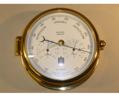 SEWILLS SHIPS BAROMETER WITH THERMOMETER AND HYGROMETER DIALS IN A BRASS CASE (DIA: 18 cm)