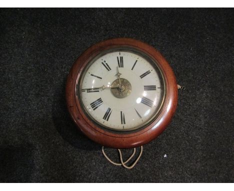 A late 19th Century postman's alarm wall clock, with black Roman numerals to the 22cm diameter cream painted wood face, the m