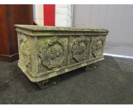 A concrete garden trough depicting cameos of a lady on two feet 28cm high, 70cm wide