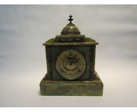 A Victorian mantel clock with green onyx case of architectural form showing a visible escapement wheel, the movement hung wit