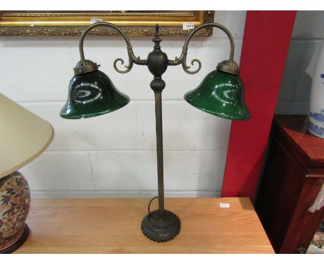 A bronzed effect twin sconce table lamp with dark green glass shades