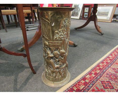 An embossed brass cylindrical umbrella and stick stand with tavern scene