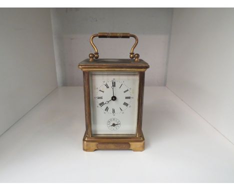 An English brass cased carriage clock with Roman numerated dial