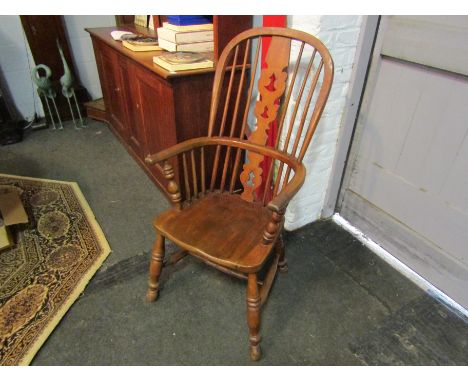 A Windsor elbow chair with stick back and carved splat on h-stretcher with turned legs