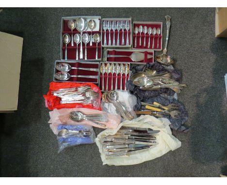 A bag containing plated flatware including boxed sets, ladle etc.